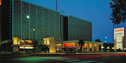 The Maxim Hotel and Casino on Flamingo Road at dusk in 1977 with its sign lit