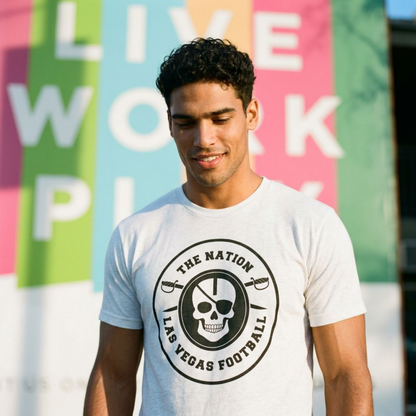 Man wearing the white Nation Skull & Swords Las Vegas football T-shirt in front of a colorful mural