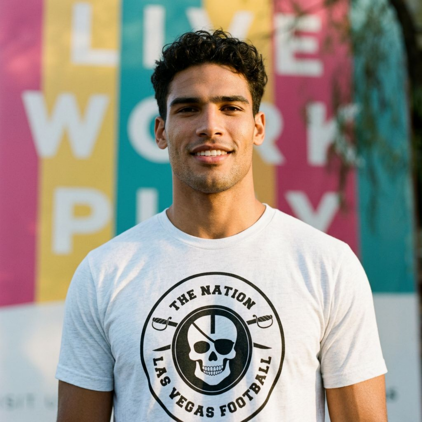 Close-up of a man wearing the white Nation Skull & Swords Las Vegas football T-shirt